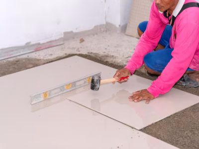 Tiling Works worker laying ceramic tile floor knock smooth floor 330609 1325.avif